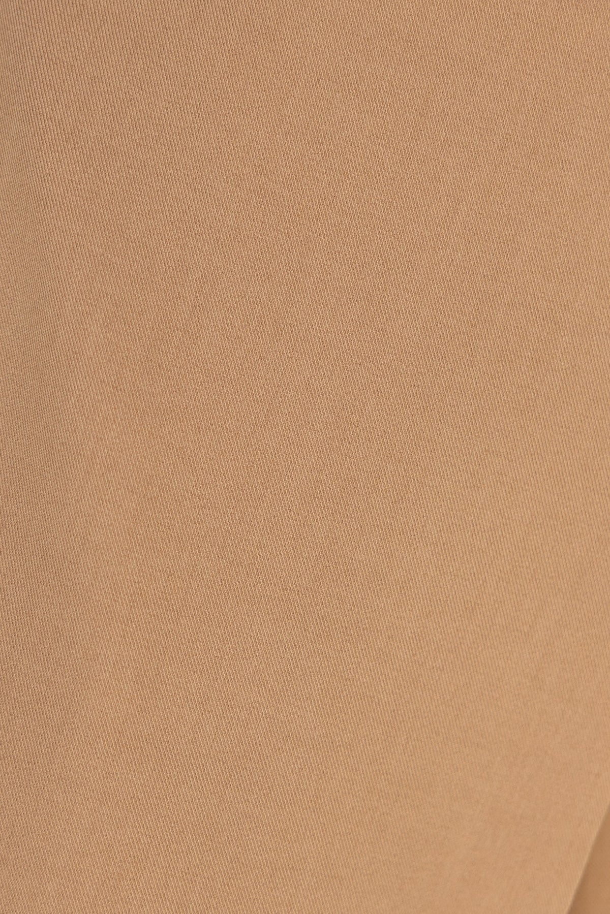 Close-up of soft, beige fabric of Oxford Pants, showcasing texture and color.