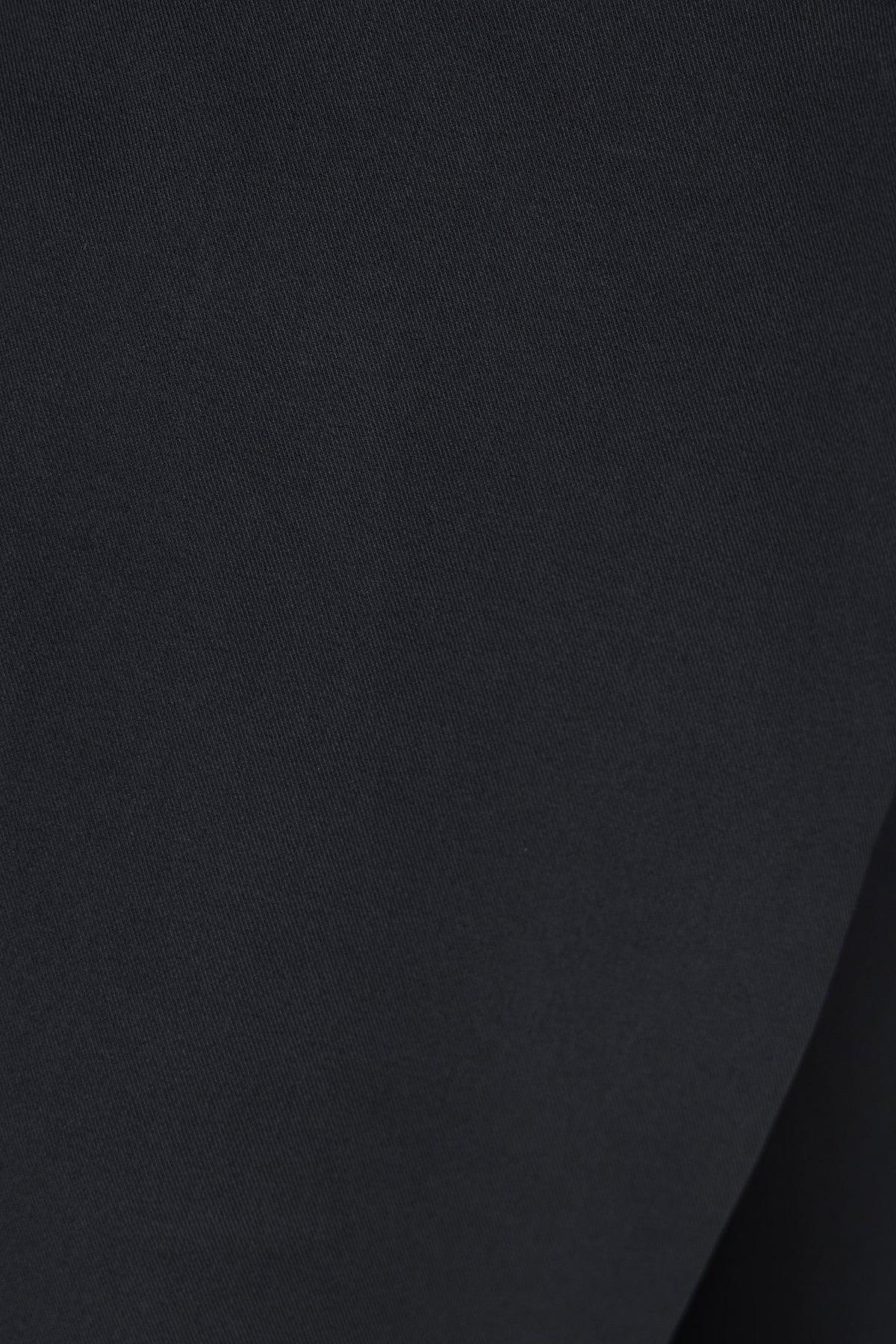 Close-up of black textured fabric for an Oxford top with a smooth finish.