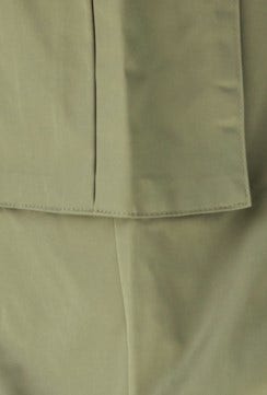 Close-up of Omar Cargo Pants fabric in olive green, showcasing the smooth texture and detailed stitching.