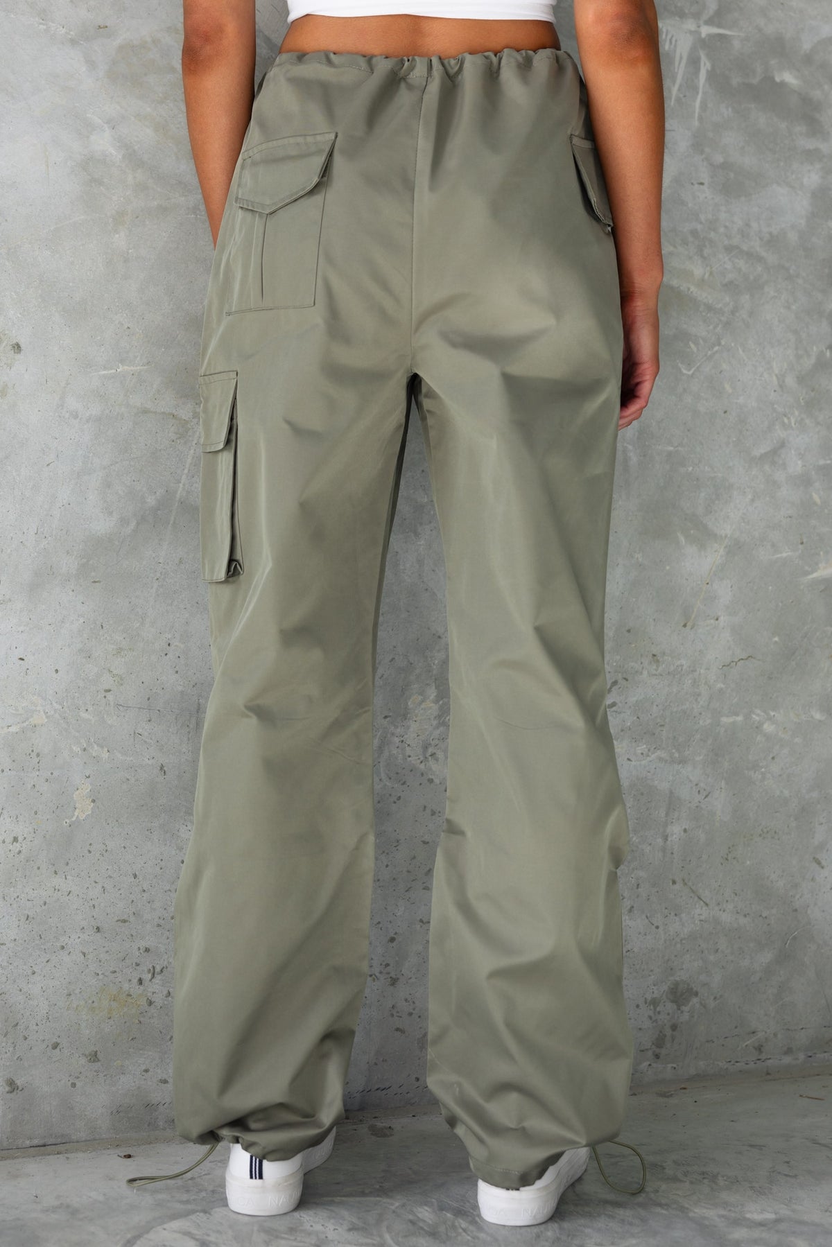 Omar Cargo Pants in olive green, showcasing wide legs and pockets from the back view, perfect for a stylish casual look.