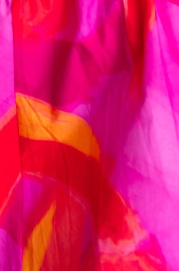 Close-up of vibrant pink and orange fabric pattern, showcasing the lightweight cotton material of the Archer Maxi Dress.