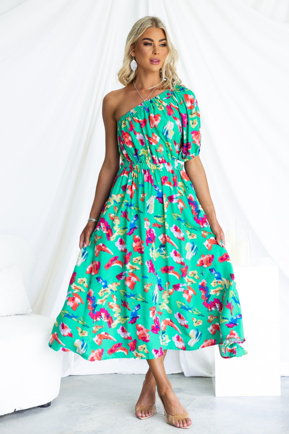 Charmayne Midi Dress featuring a one-shoulder neckline, colorful floral print, and pockets for a vibrant summer look.