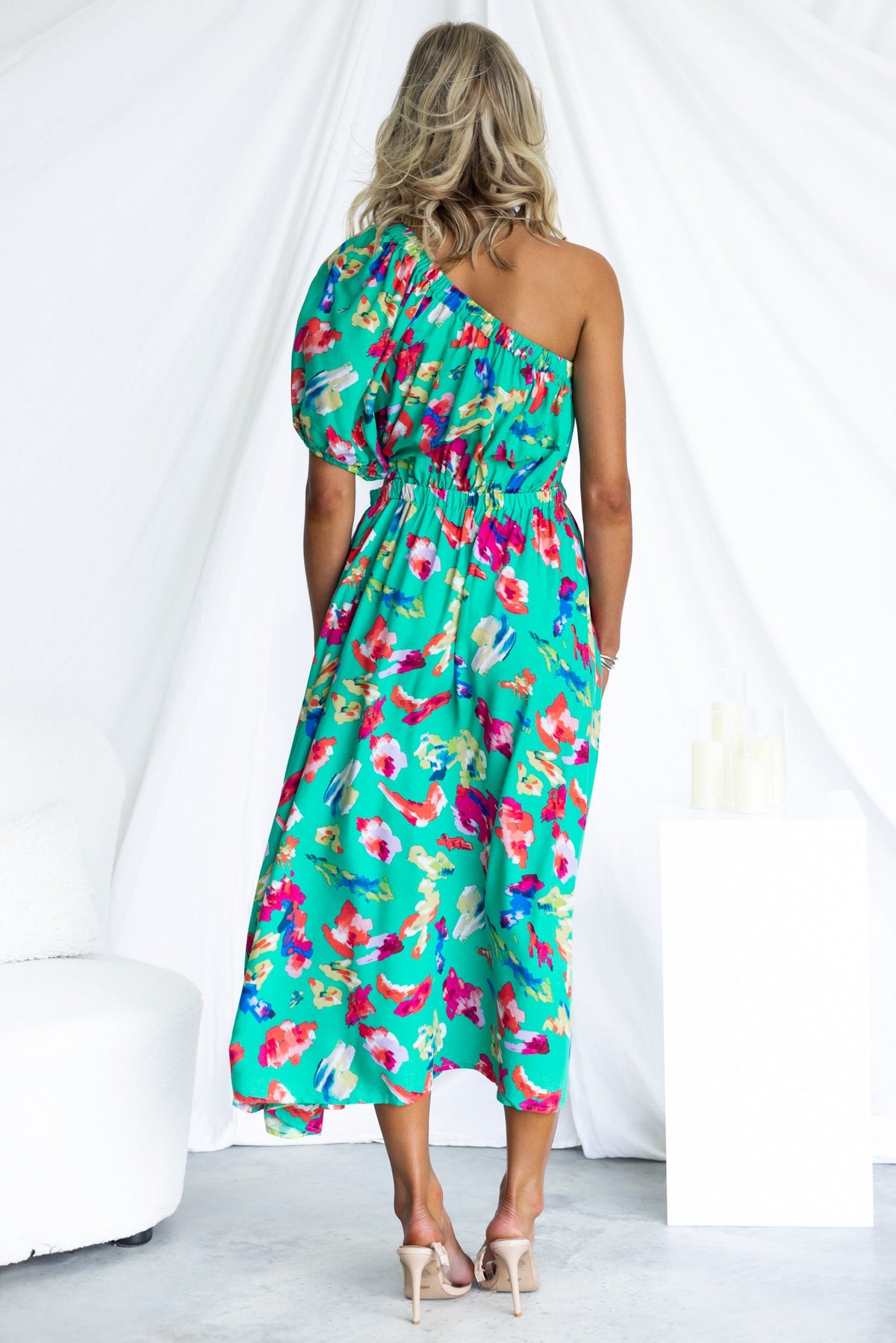 Back view of Charmayne Midi Dress with one-shoulder neckline, vibrant floral pattern, and elastic waist, perfect for summer events.