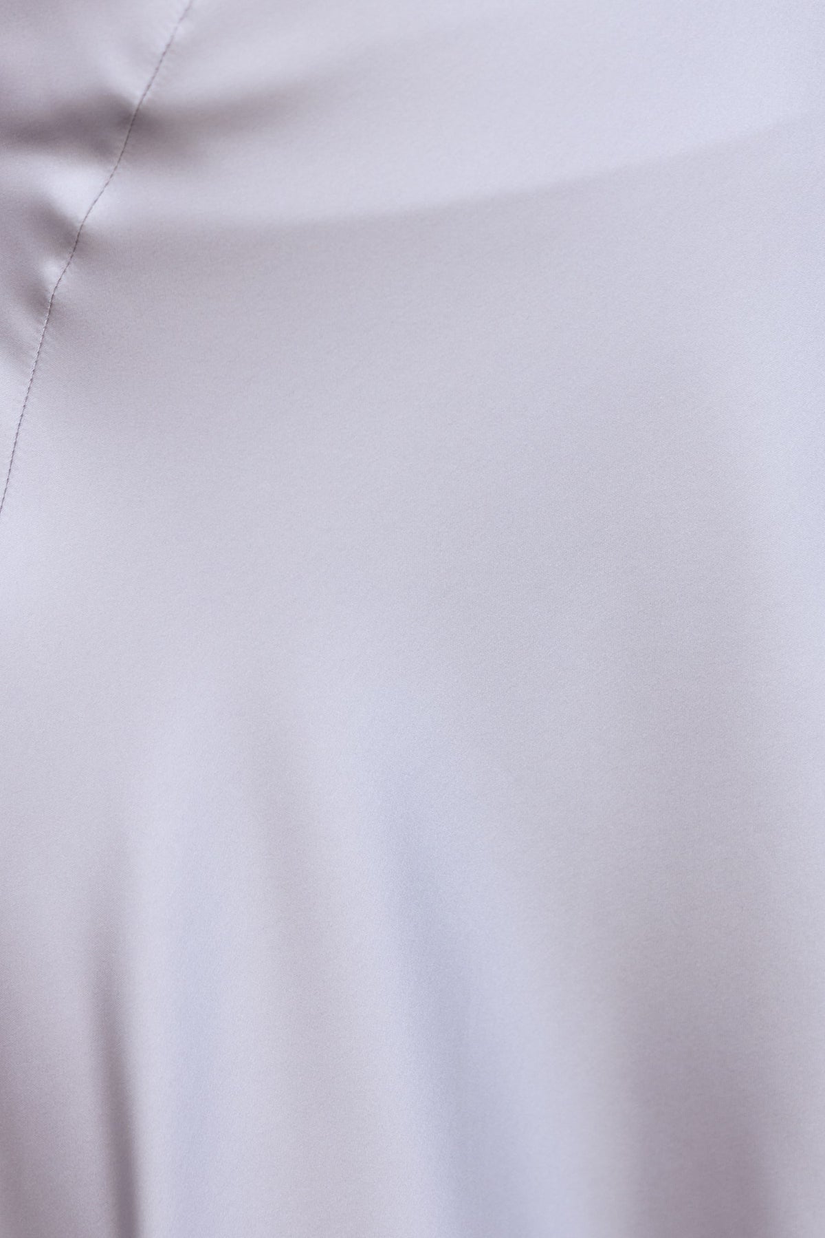 Close-up of smooth, satin fabric texture of Giallo Midi Skirt, showcasing its non-stretch and elegant feel.