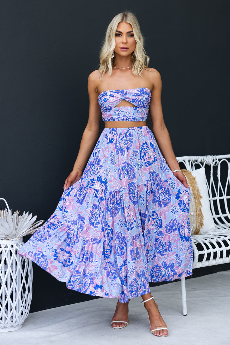 Enchanting maxi skirt with floral print and mid-high waist, styled on model against a black background.