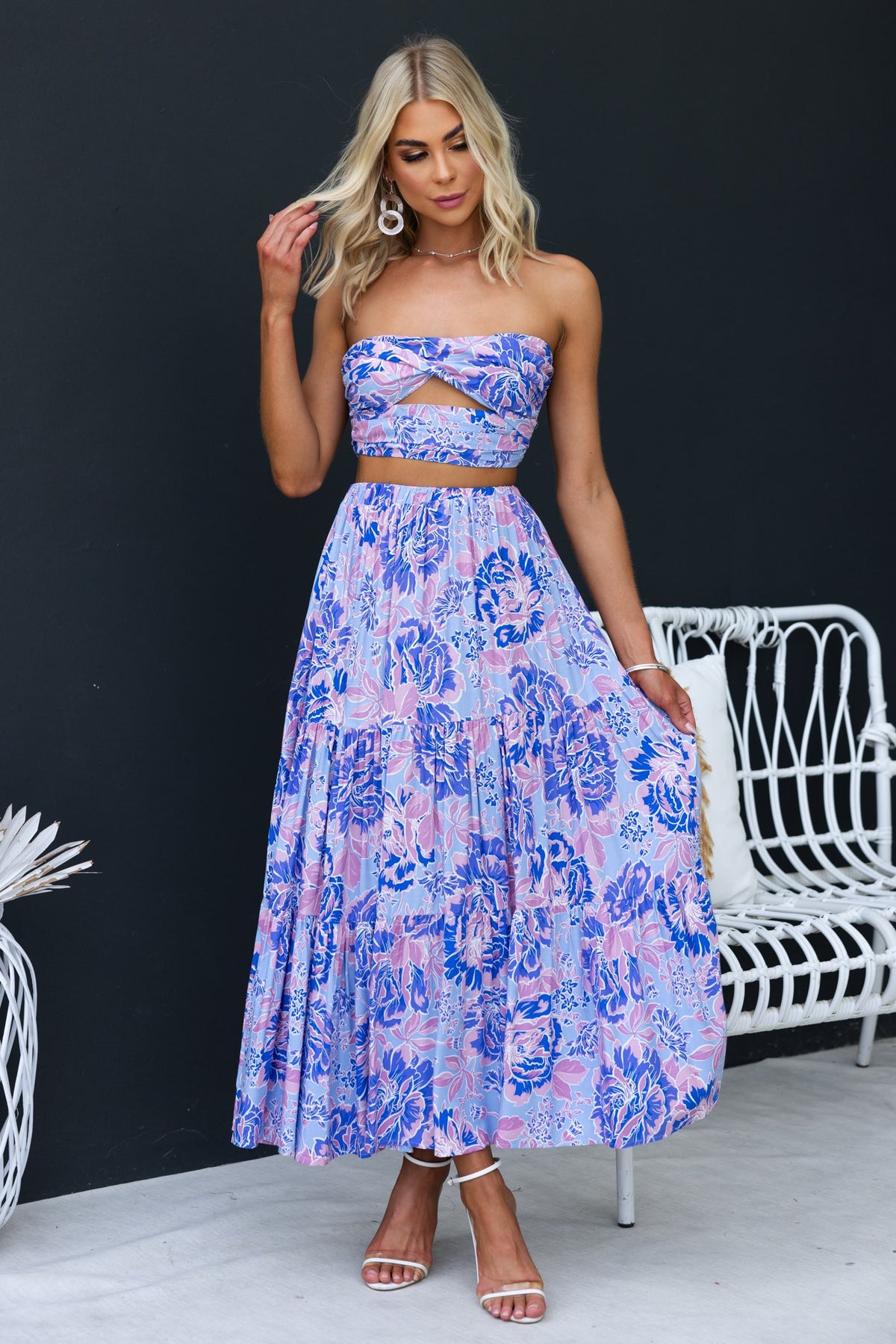 Model wearing an enchanting strapless top and floral skirt ensemble, perfect for summer occasions.