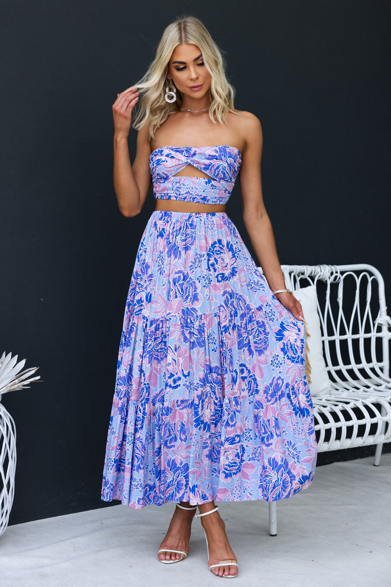 Model wearing an enchanting strapless top and floral skirt ensemble, perfect for summer occasions.