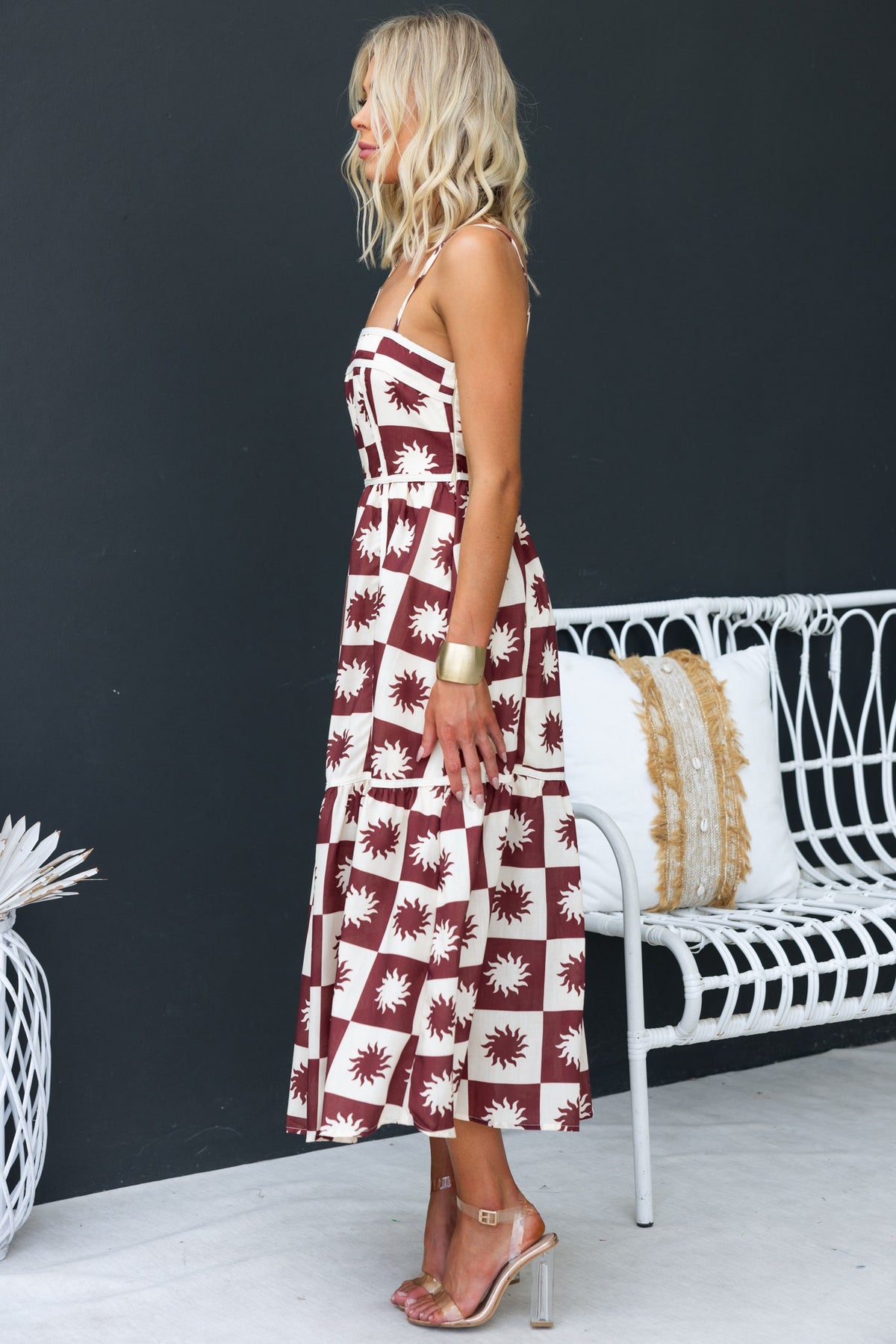 Cianna Midi Dress with adjustable straps, side zip, and floral print in brown and cream on a model, styled with heels.