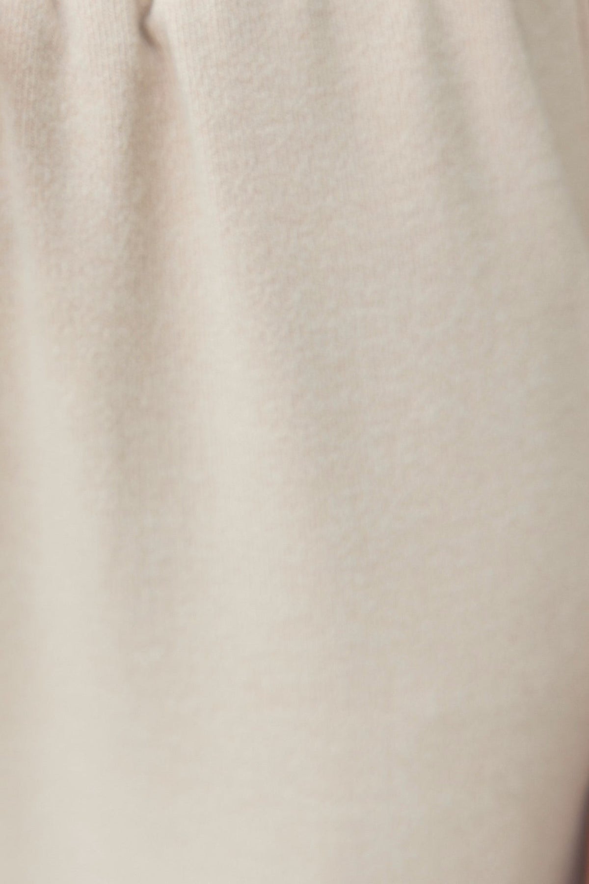 Close-up of textured cream fabric for Lanza Top, displaying soft material with a slight stretch.