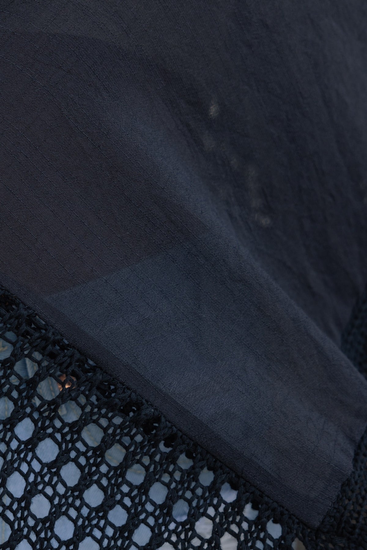 Close-up of the Grateful Throwover featuring bat-wing sleeves and intricate crochet detailing.