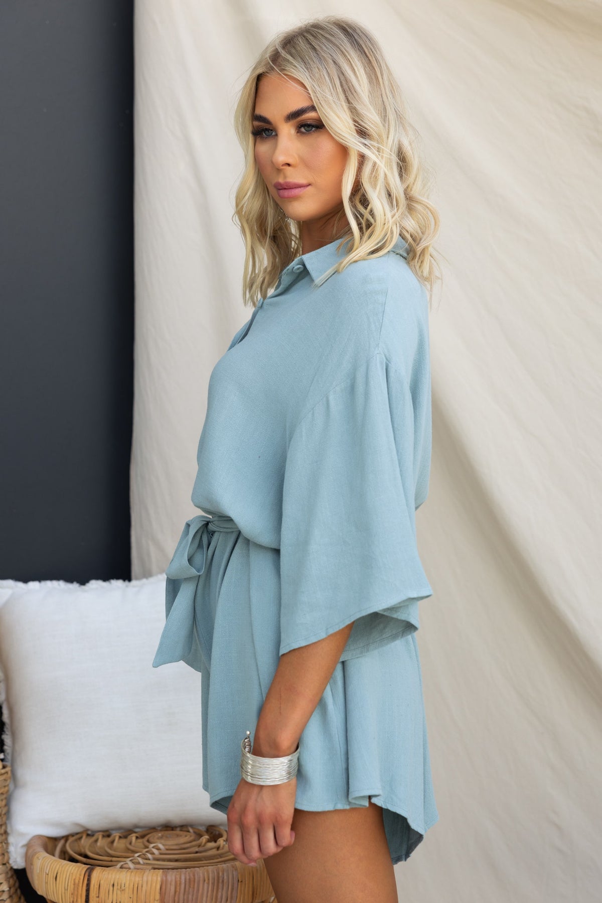 Light blue Wyoma Playsuit with a collar and tie, showcasing a relaxed fit and stylish design on a model.