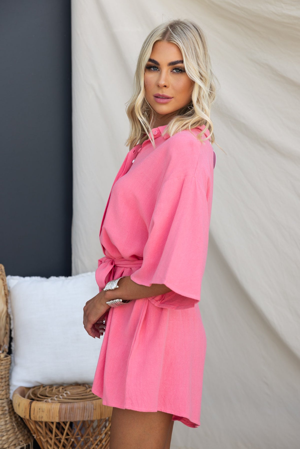 Model wearing a pink Wyoma Playsuit with a collar and tie, showcasing a relaxed fit and linen-like texture.