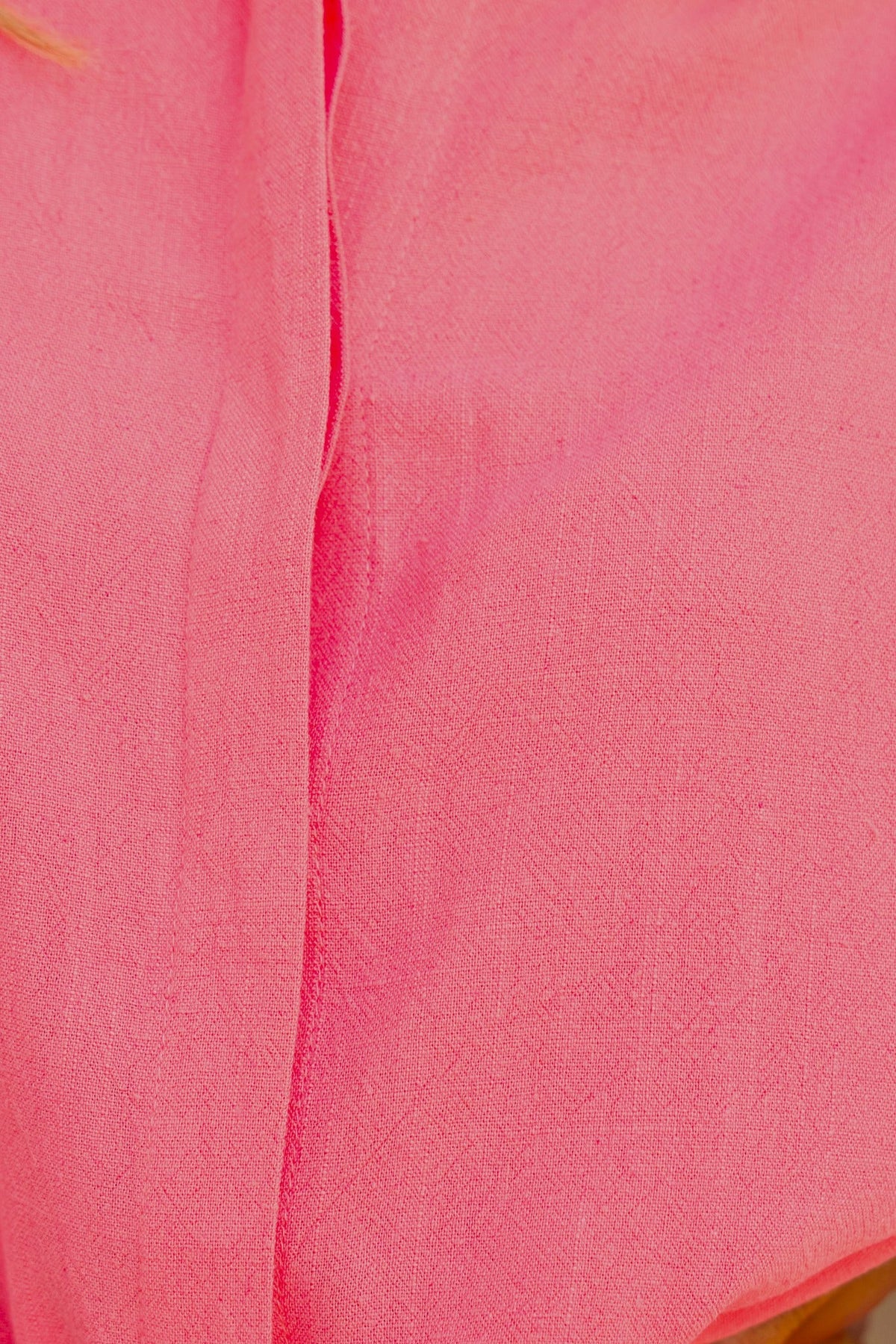 Close-up of bright pink fabric showcasing soft texture and drape for the Wyoma Playsuit.
