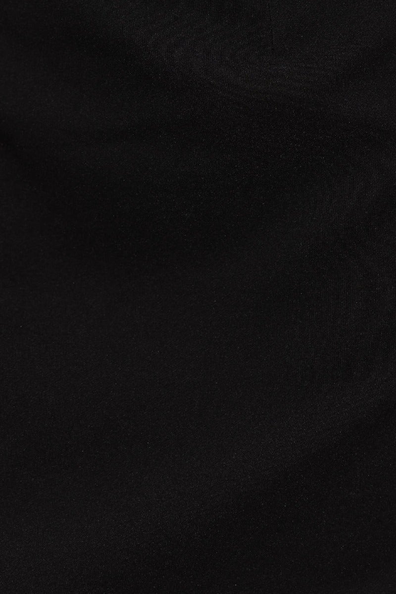 Close-up of luxurious black fabric showcasing smooth texture for an elegant midi dress.