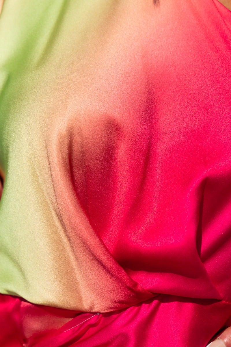 Close-up of satin fabric in gradient pink and green, showcasing the luxurious texture of the Tempest Dress by Frankie the label.