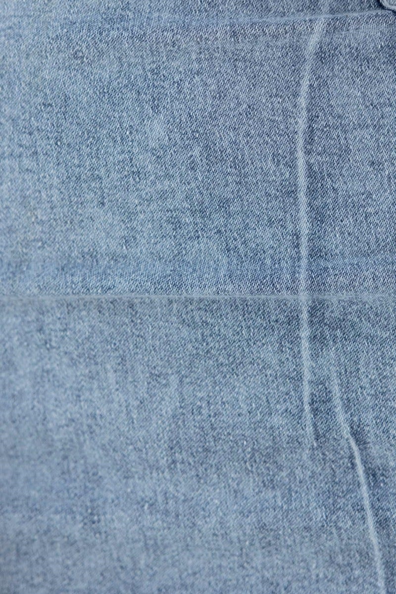 Close-up of the fabric texture of the Intentions Denim Dress, showcasing its light blue denim material.