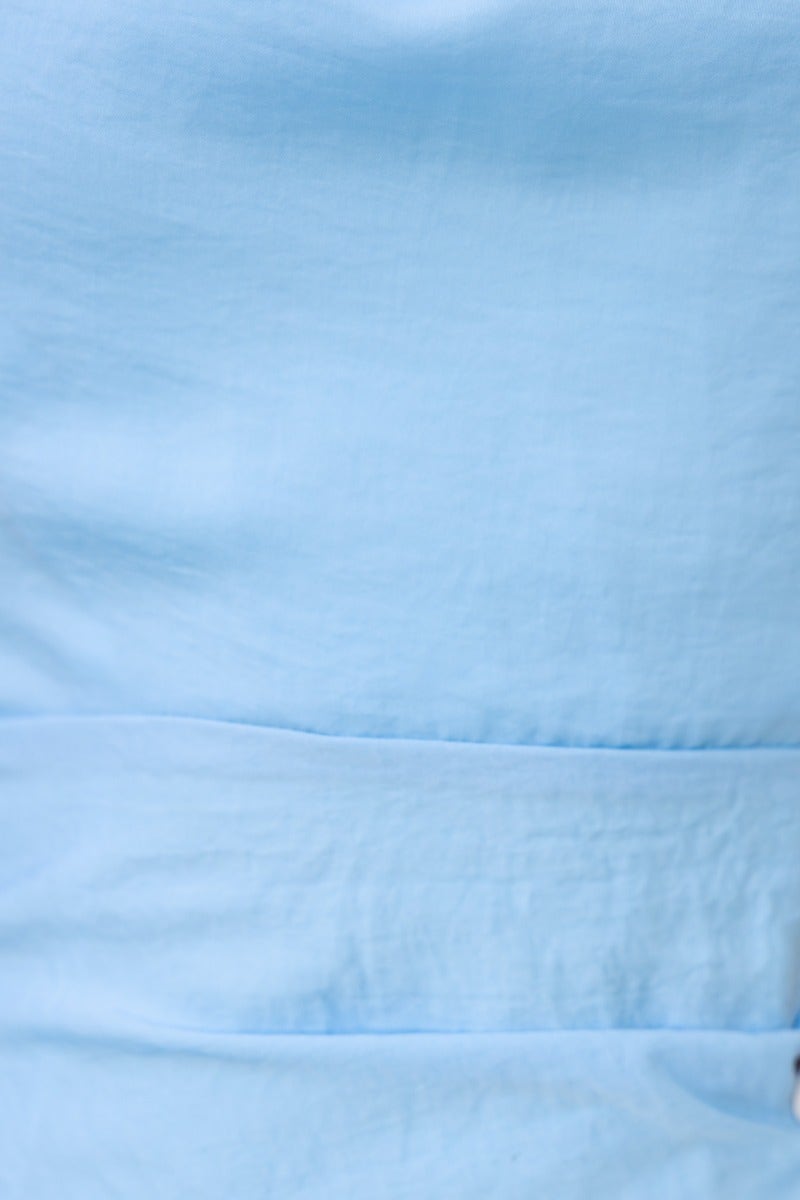 Close-up of light blue fabric from One Love Maxi Dress, showcasing the smooth texture and elegant design.