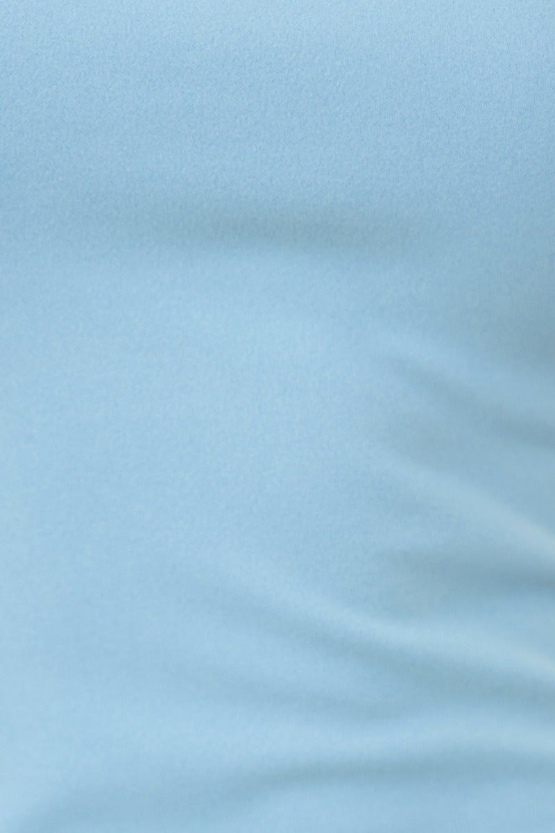 Close-up of soft, light blue fabric texture, highlighting its smooth and stretchy material.