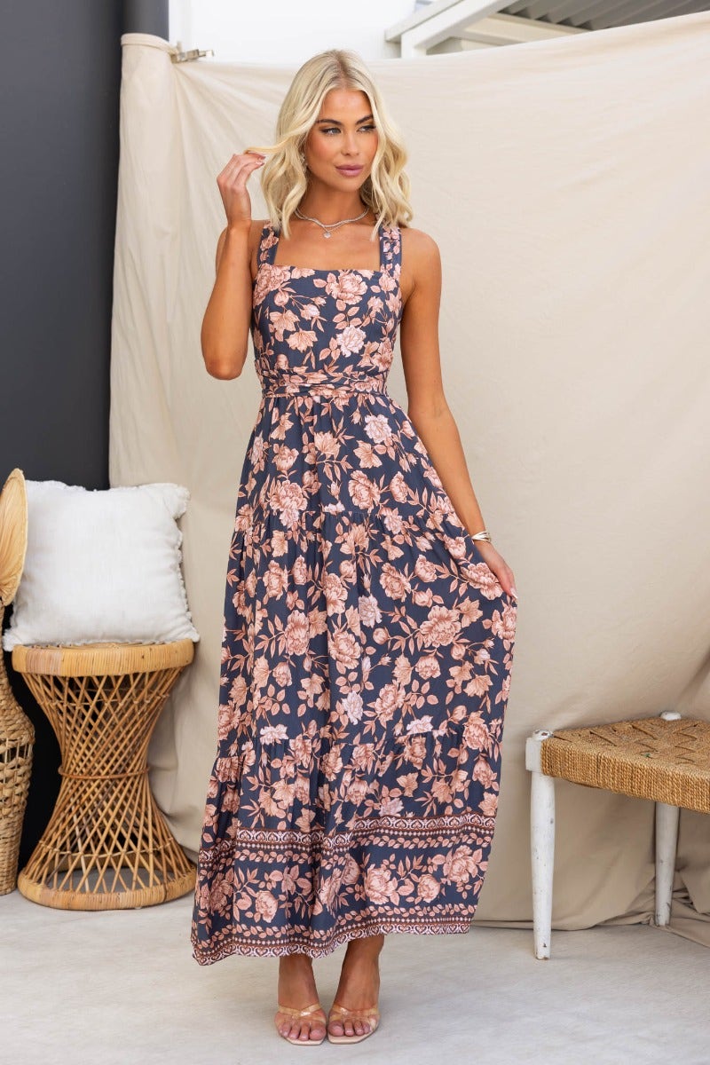 Navy floral print Etsie maxi dress with adjustable tie halter neckline and pockets, model wears size 8/S.