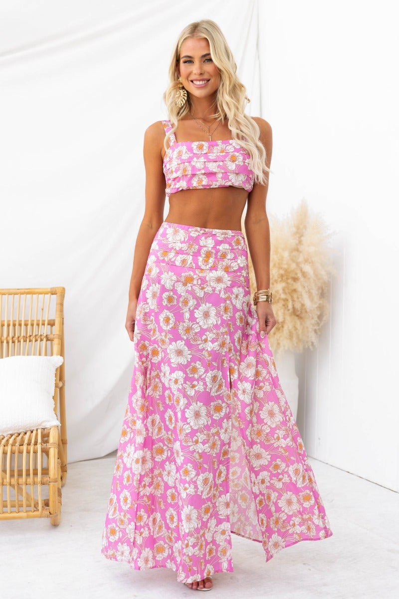Model wearing a floral print Last Summer Maxi Skirt with a matching crop top, showcasing high splits and a mid-high waist fit.