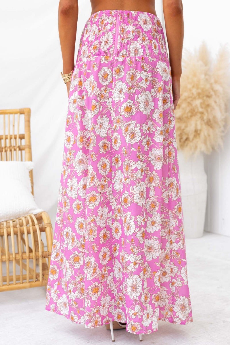Back view of a floral print pink maxi skirt with high splits and mid-high waist design, ideal for summer styling.