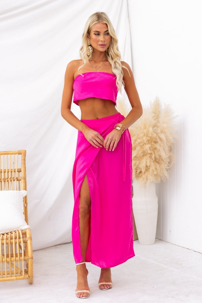Model wearing a vibrant pink Nerida Top with a matching skirt, showcasing a stylish summer look.