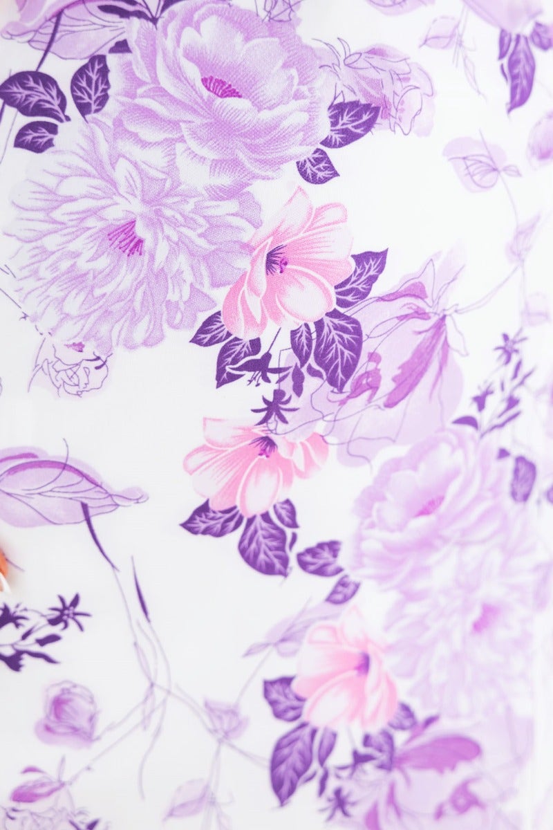 Close-up of floral pattern featuring purple and pink flowers on a white background, ideal for a maxi dress design.