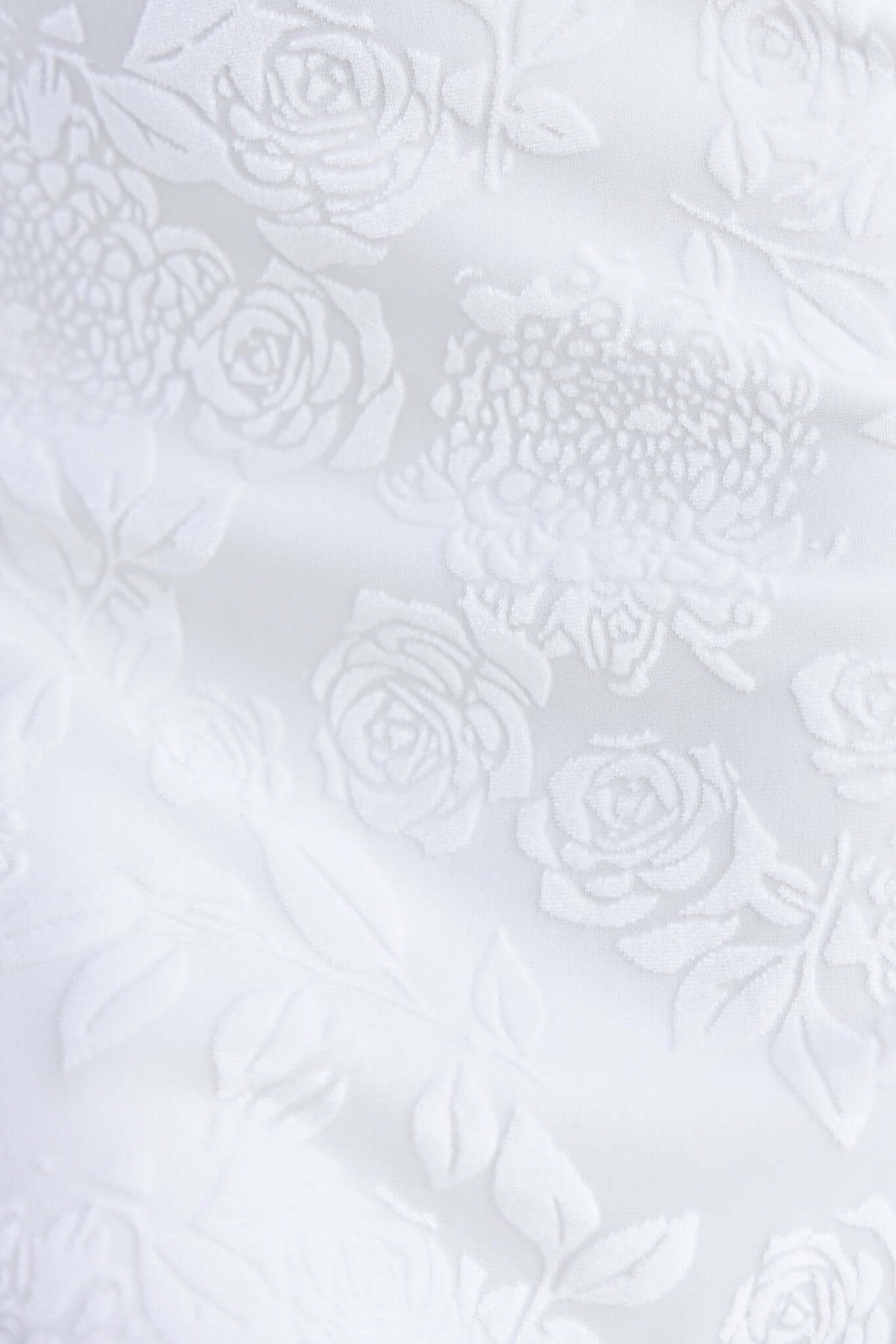 Embossed velvet print featuring delicate white rose patterns on a soft background, perfect for a stylish maxi dress.