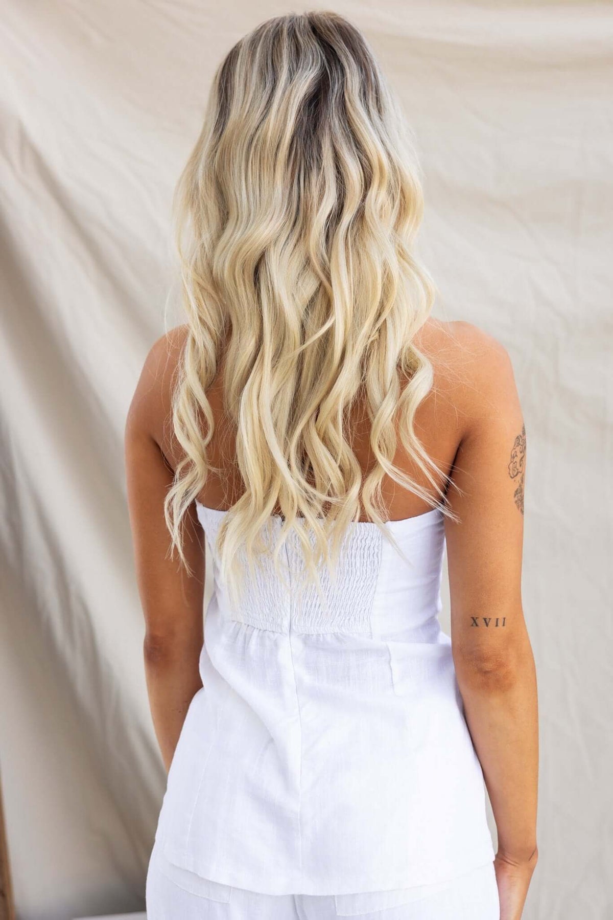 Back view of a woman in a strapless Irina Top featuring a linen look and anti-slip bust design.