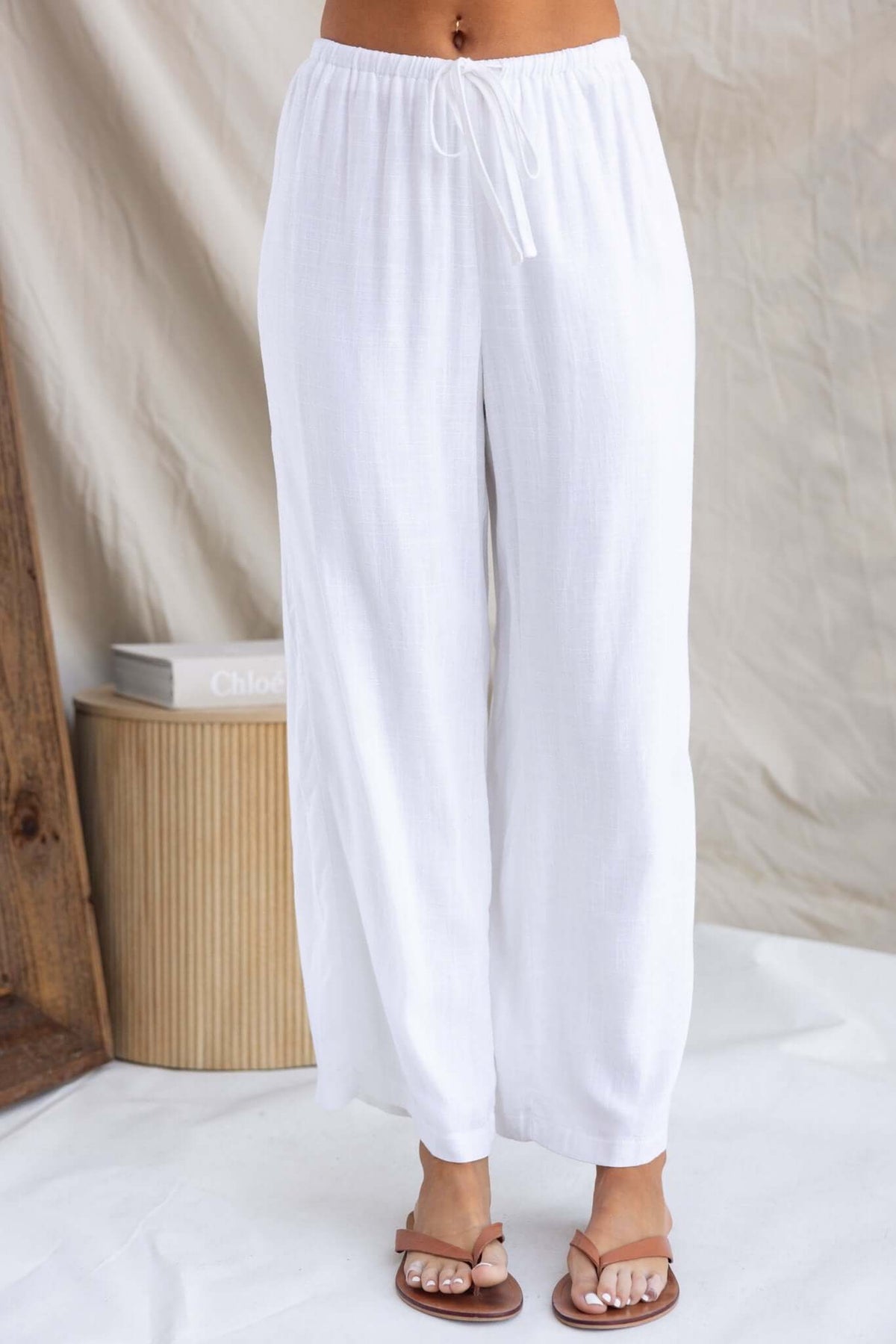 Irina Pants in white with elastic waistband and drawstring, featuring a relaxed fit and back pockets.