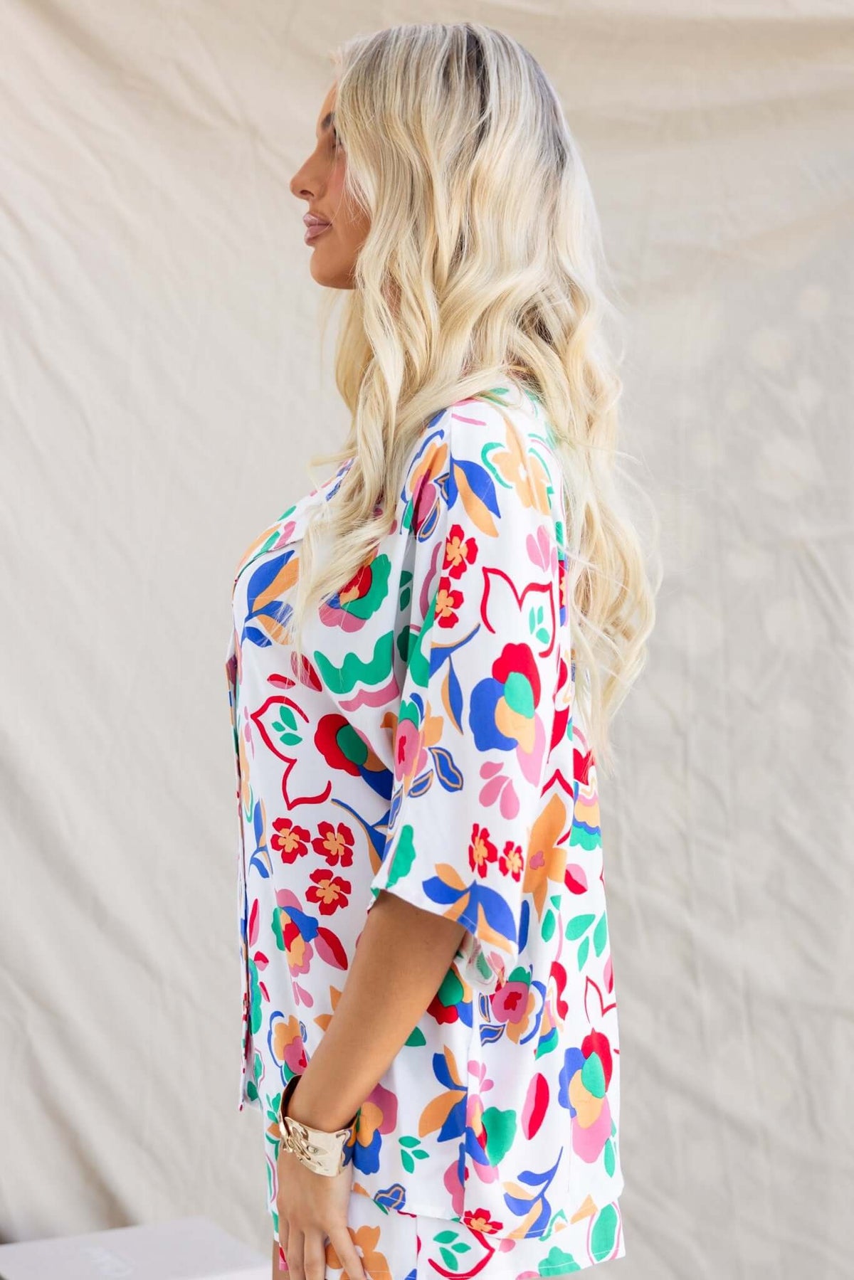 Stylish woman in a colorful floral Bonito shirt with a relaxed fit, showcasing the vibrant design and light fabric.