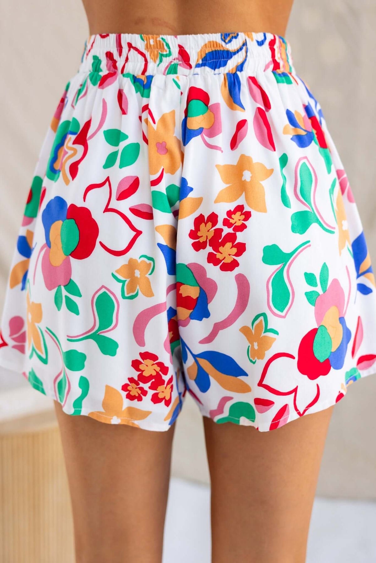 Bonito Shorts featuring a colorful floral pattern and elastic waistband, perfect for summer wear.