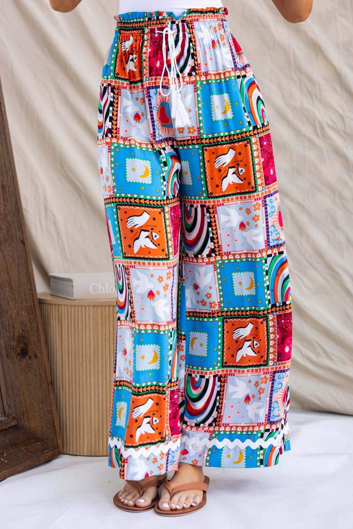 Maito Pants featuring a colorful patchwork design, mid-high waist, elastic waistband, and pockets. Perfect for casual wear.