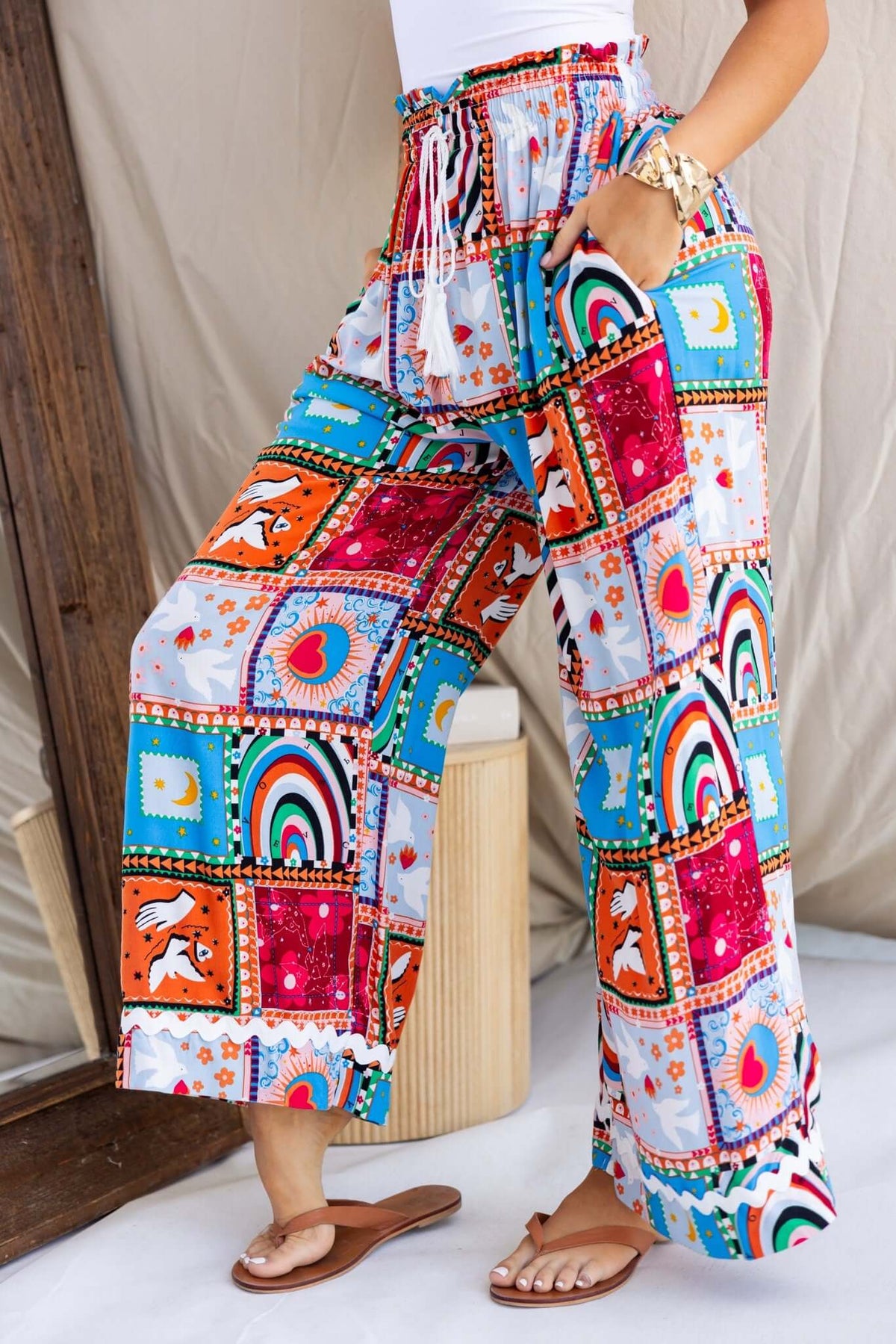 Maito Pants featuring a colorful patchwork design, mid-high waist, elastic waistband, and pockets for casual comfort.