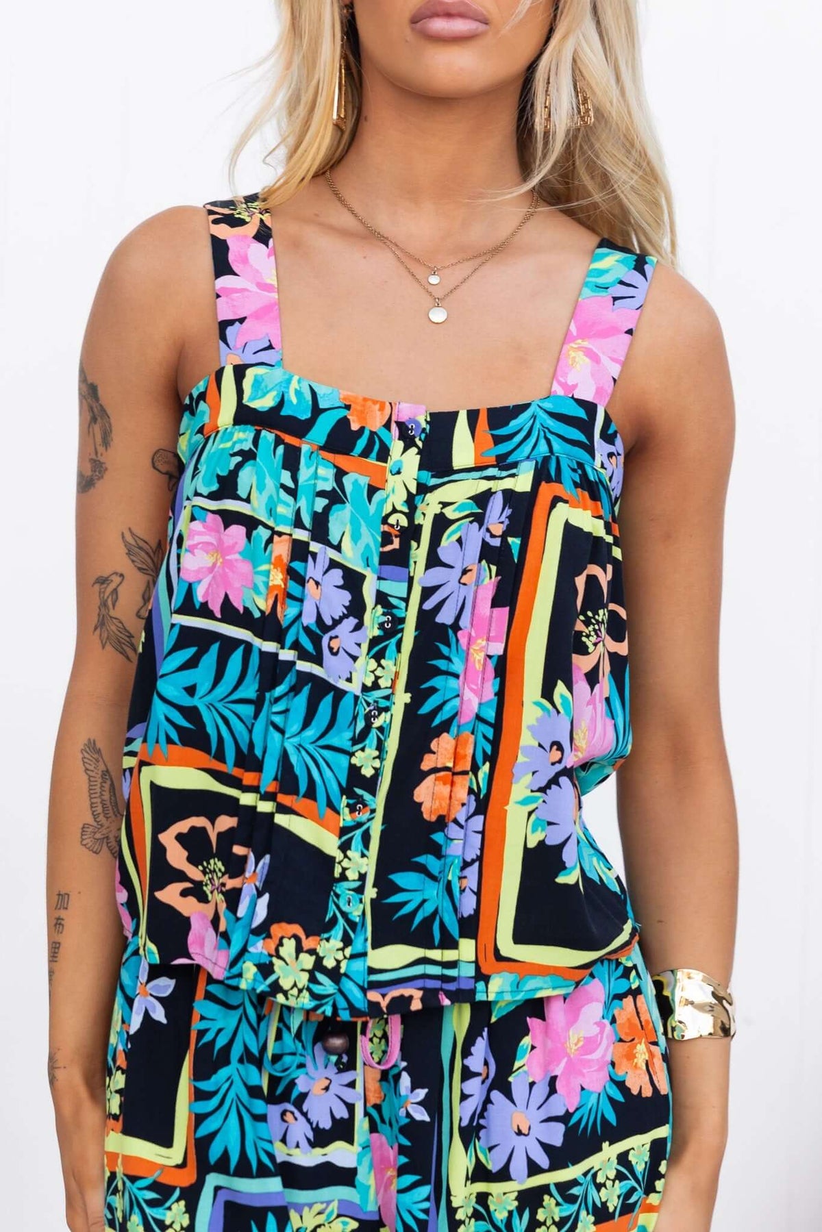 Delray Top featuring adjustable straps and button-up front in vibrant floral and tropical print, perfect for summer style.