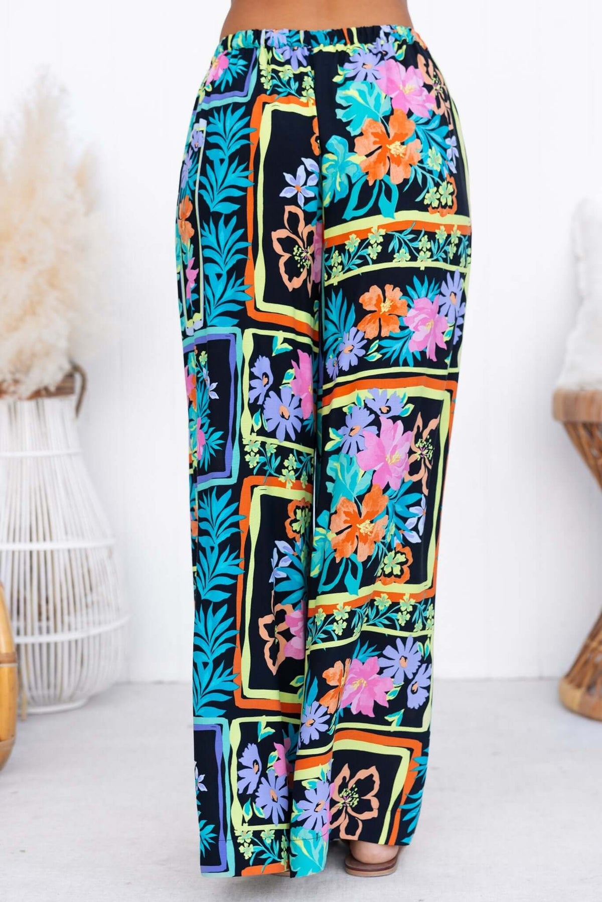 Colorful floral patterned Delray Pants with a mid-high waist and elastic waistband, perfect for stylish comfort.