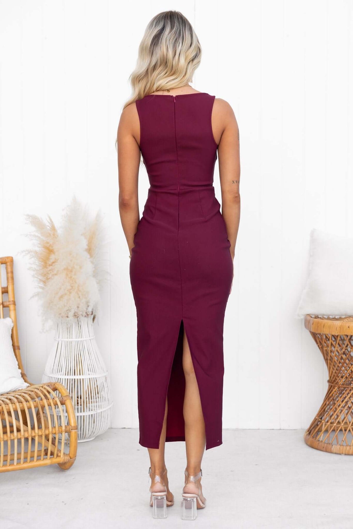 Back view of a maroon Maris Maxi Dress featuring a high neckline and a stylish back split.
