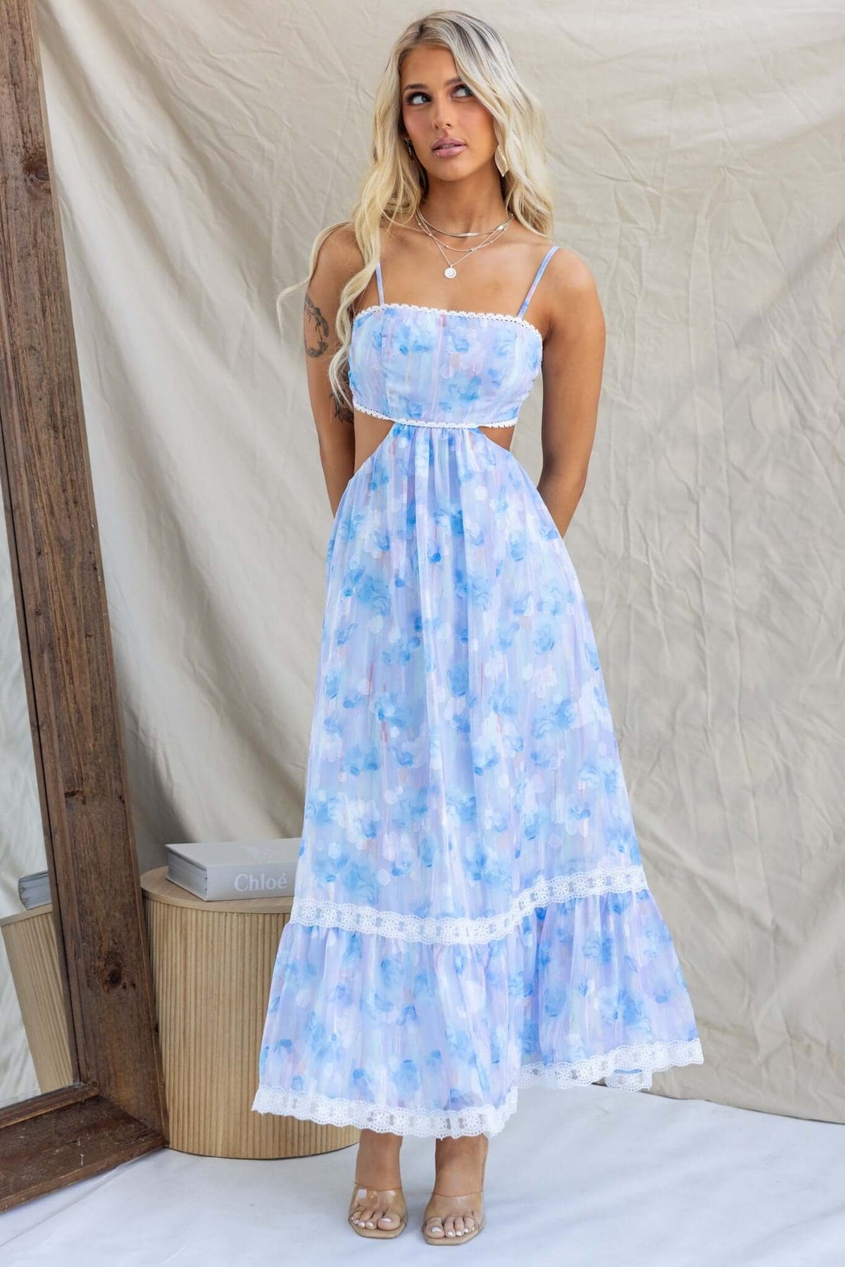 Klair Maxi Dress with adjustable straps and back cut-out in blue floral design, perfect for summer occasions.