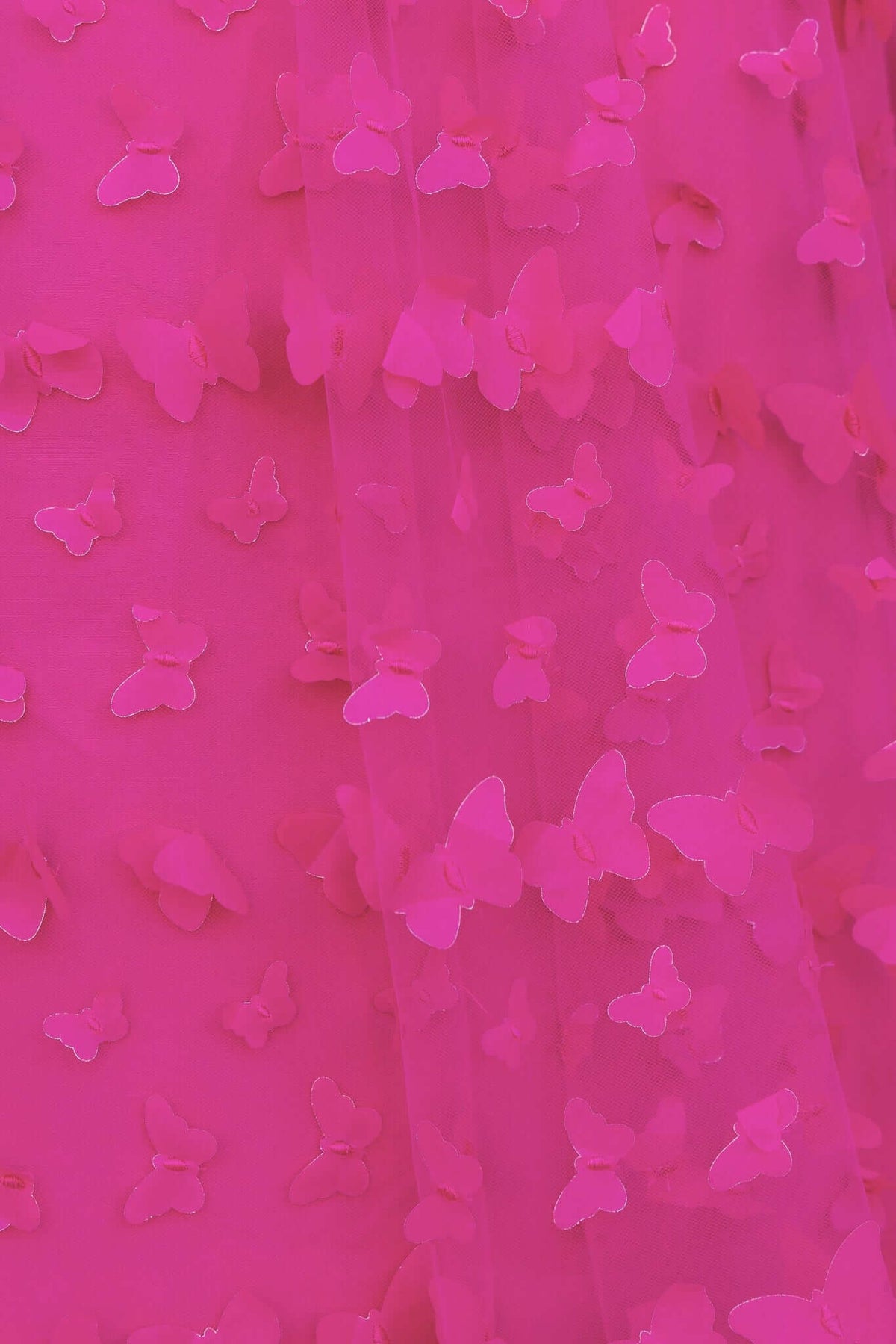 Close-up of pink tulle fabric with butterfly appliqués, perfect for a Violette Maxi Dress design.