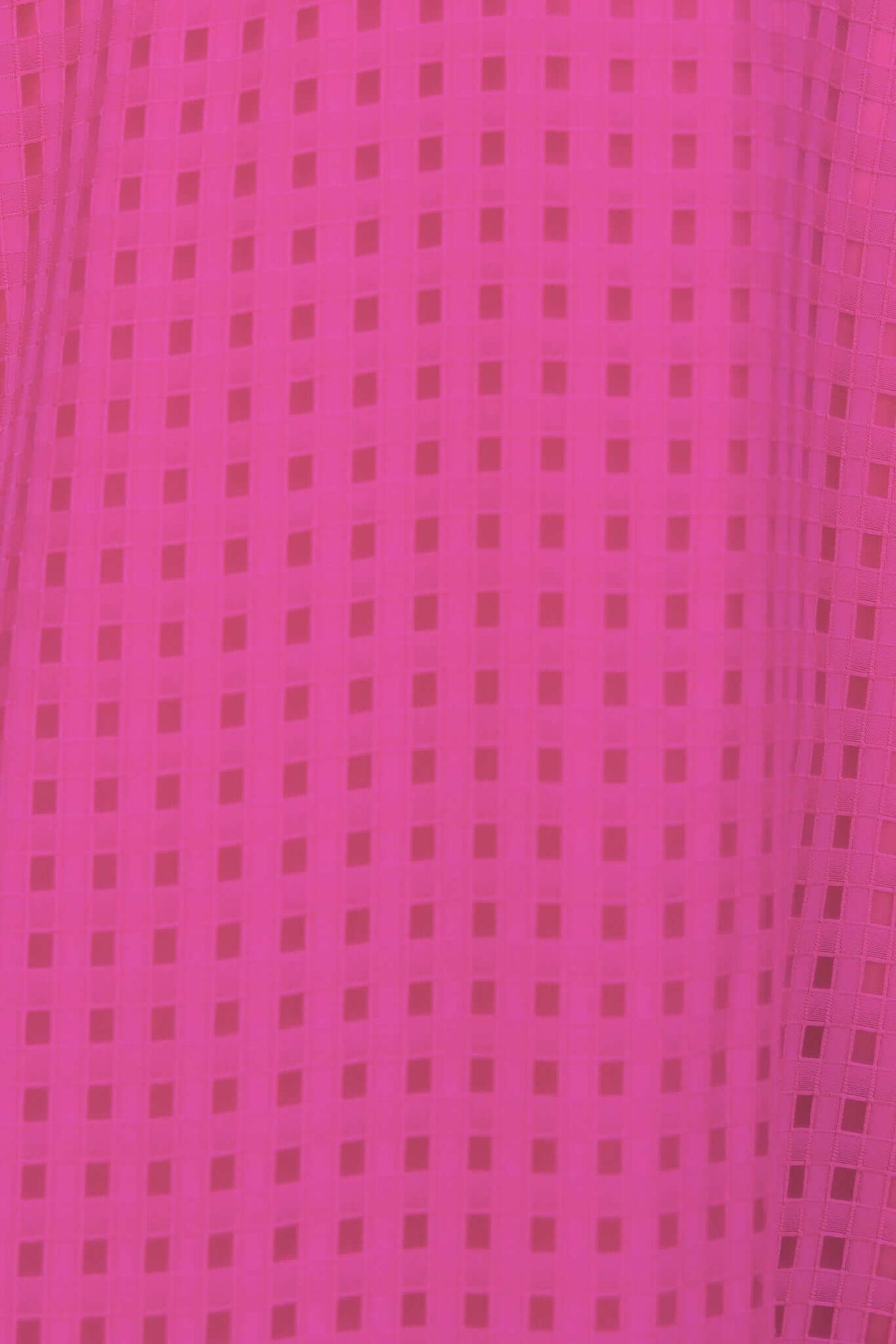 Close-up of textured pink fabric with square patterns, ideal for the Nosita Midi Dress.