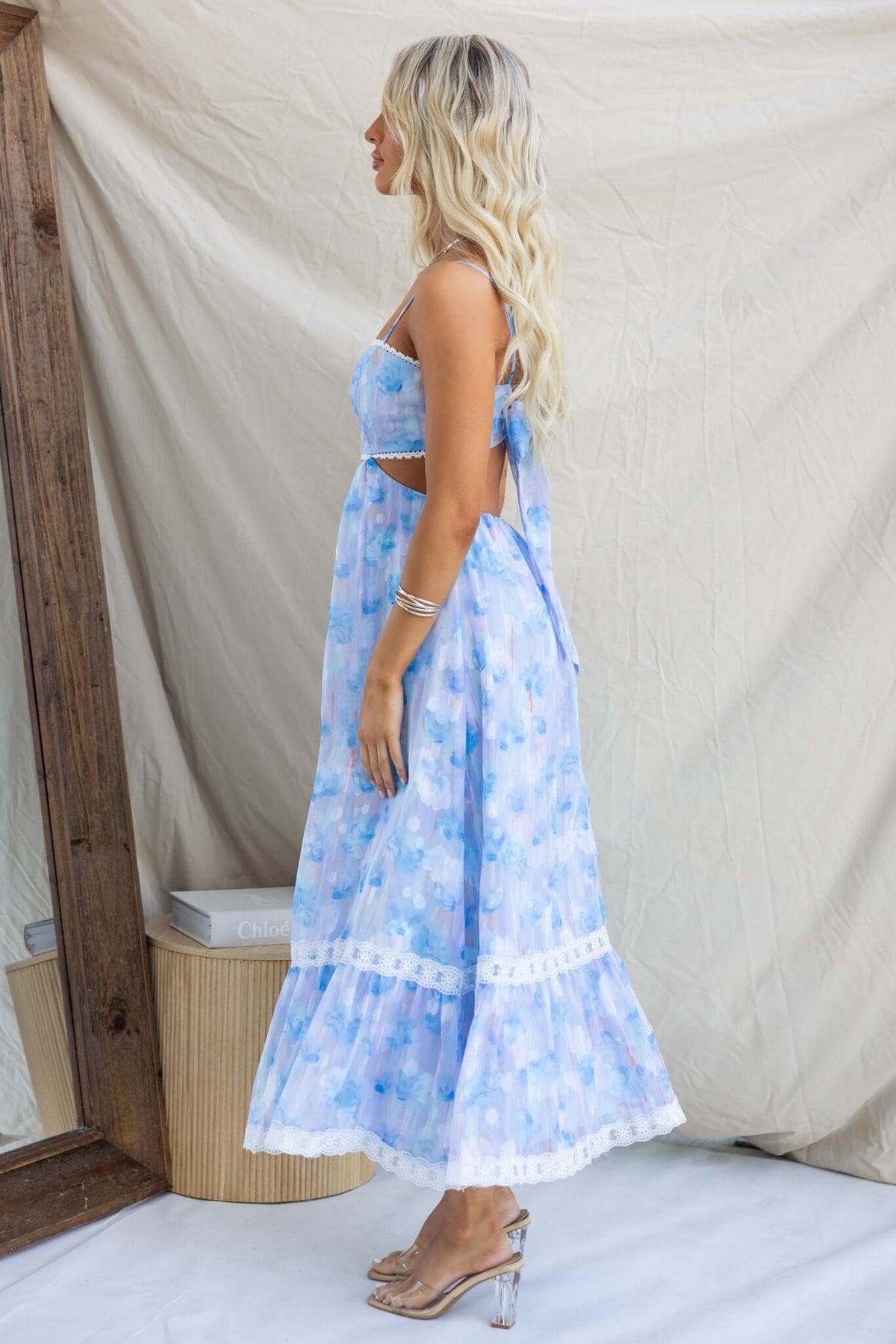 Side view of Klair Maxi Dress featuring adjustable straps, a back cut-out, and a floral blue print.