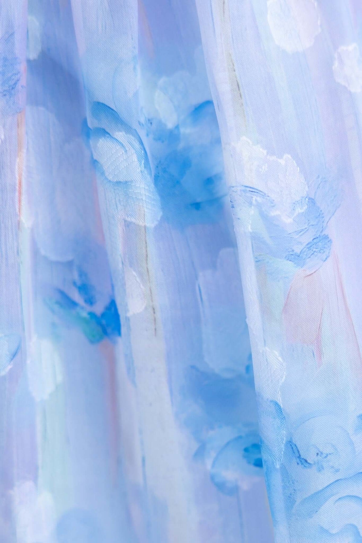 Close-up of blue floral print on airy fabric of the Klair Maxi Dress, featuring a delicate and light design.