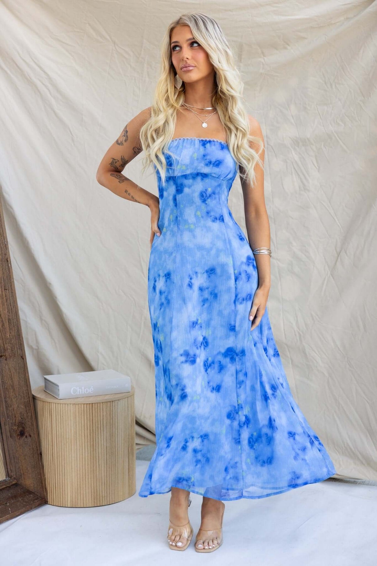 Tamara wearing a blue tie-dye strapless Daeja Midi Dress with a flowing silhouette, showcasing summer fashion elegance.