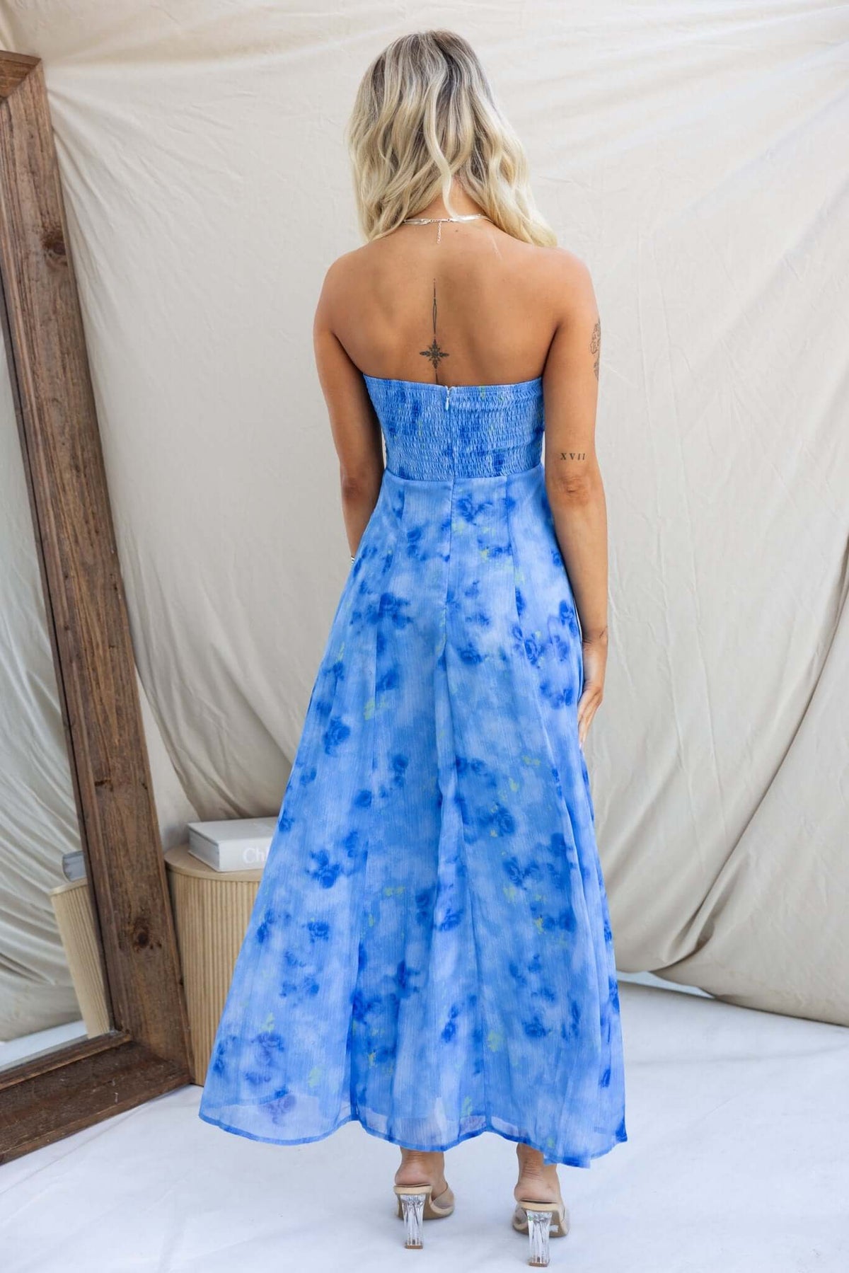 Back view of Daeja Midi Dress in blue watercolor print, featuring a strapless design and flowing skirt.
