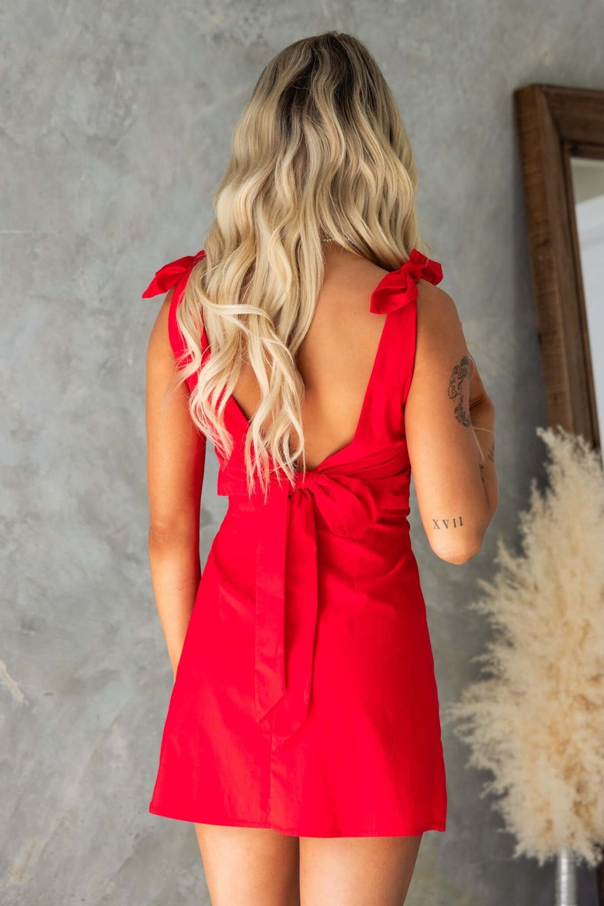 Back view of the Idaho Dress featuring tie straps and a bow detail, perfect for a stylish summer look.