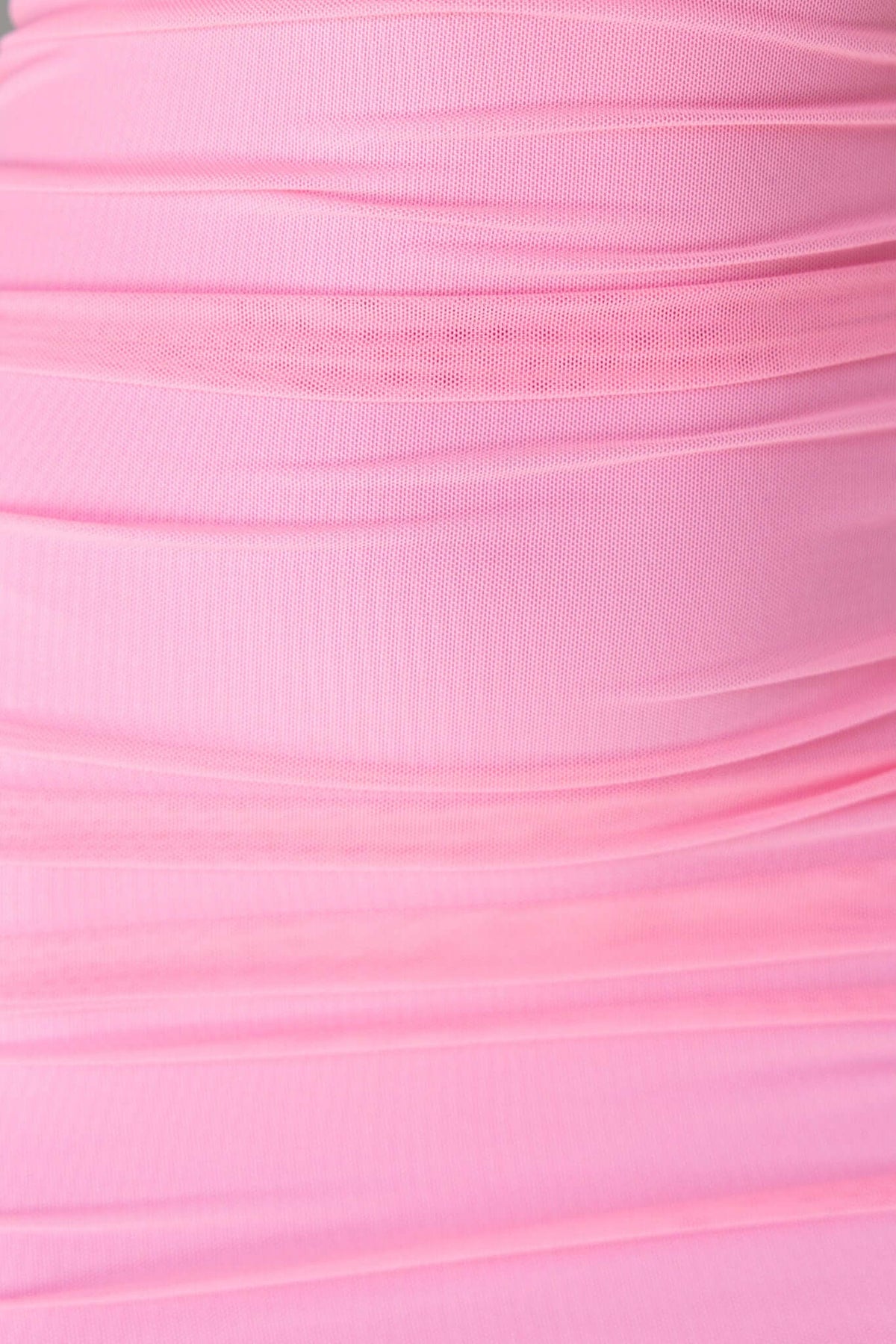 Close-up of textured pink mesh fabric with ruching, showcasing the elegant femininity of the Stolen Kiss Maxi Dress.