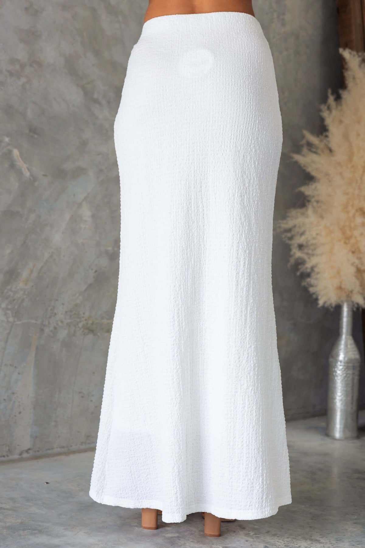 Brigitte Maxi Skirt in textured white fabric, featuring a mid-high waist and elastic waistband, perfect for elegant summer outfits.