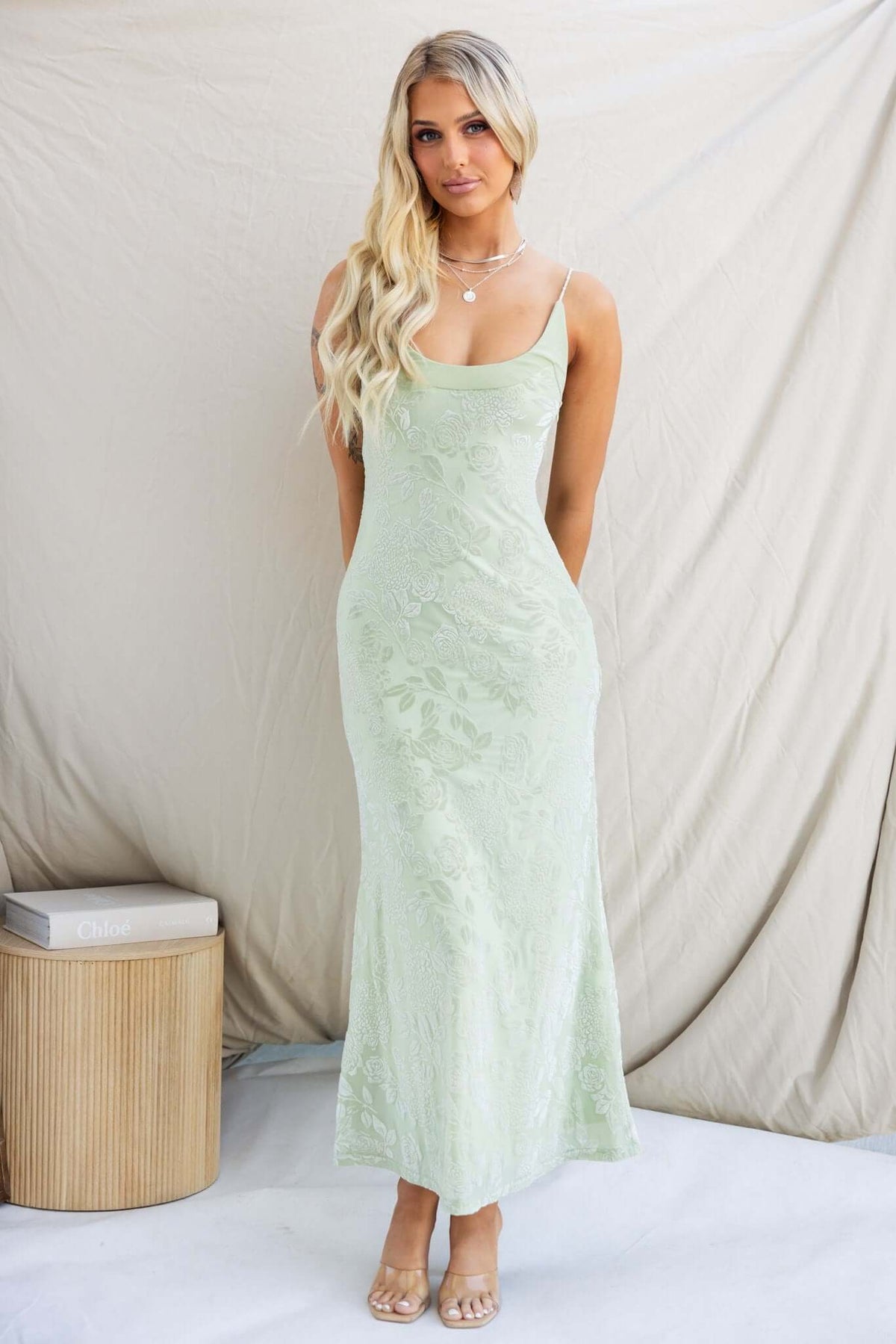 Melita Maxi Dress in soft green with embossed velvet print, adjustable straps, and a fitted silhouette.