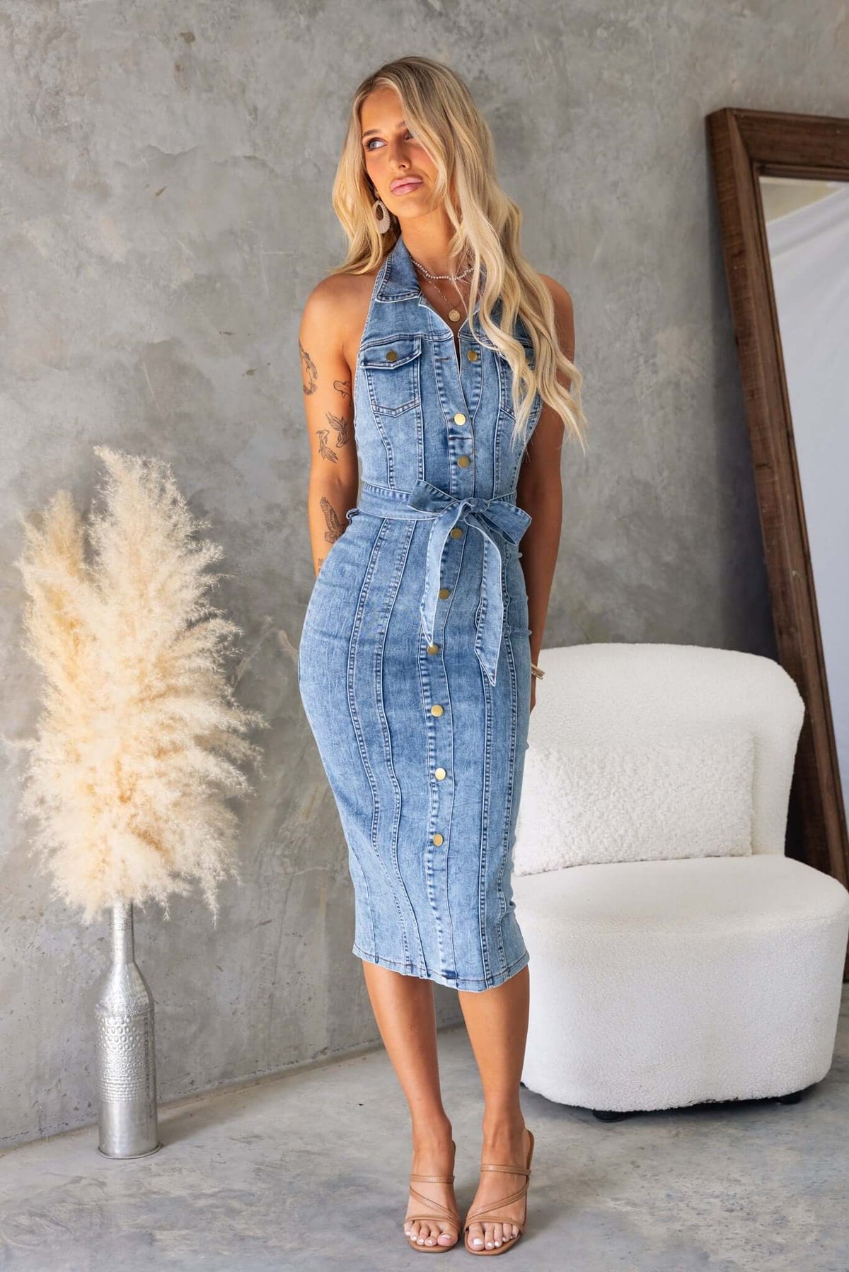 Kalyn Denim Midi Dress with high neckline, faux buttons, and removable tie, styled against a minimalist backdrop.