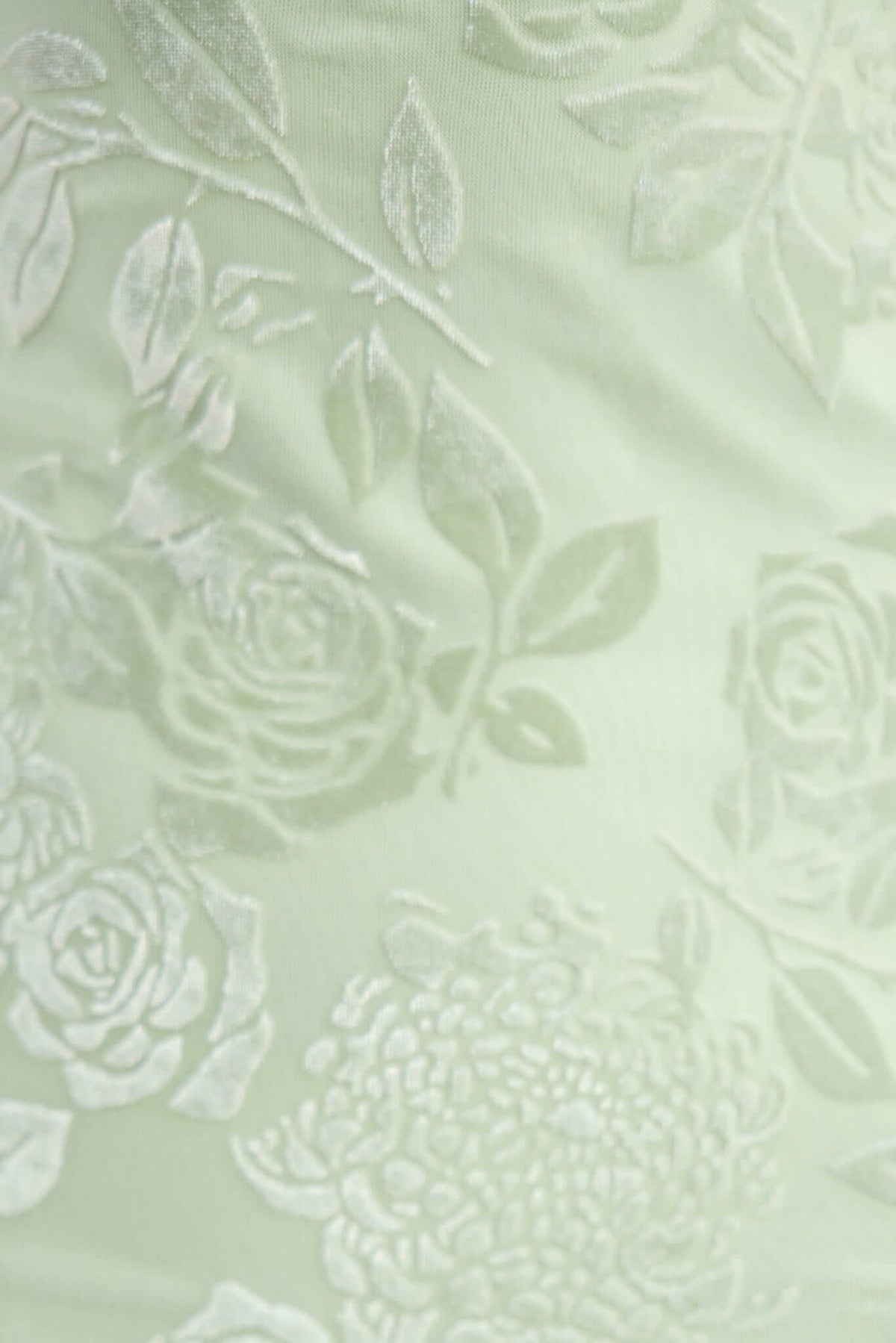 Embossed velvet print in soft green featuring floral patterns for stylish maxi dress.